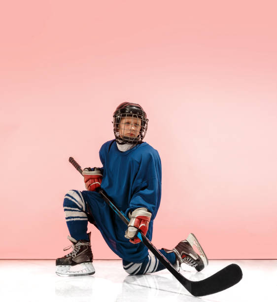 istock A hockey player with equipment over a pink background 1071415114