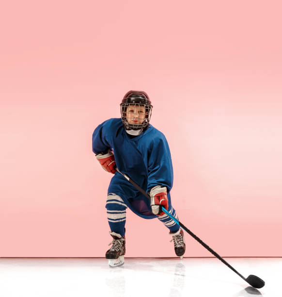 istock A hockey player with equipment over a pink background 1071415122