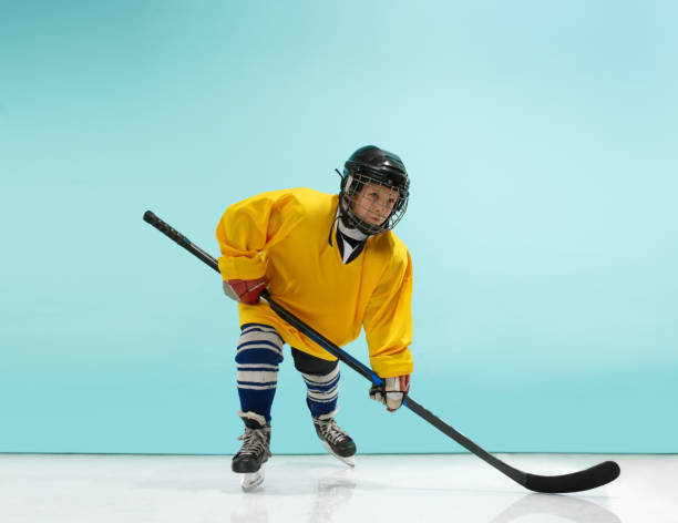 istock A hockey player with equipment over a blue background 1071415128