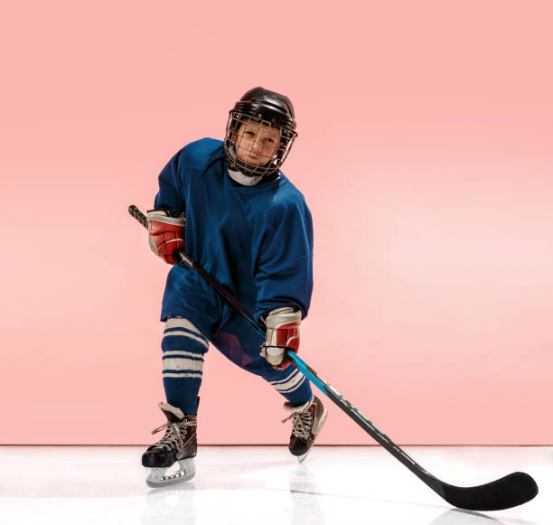 istock A hockey player with equipment over a pink background 1071415134