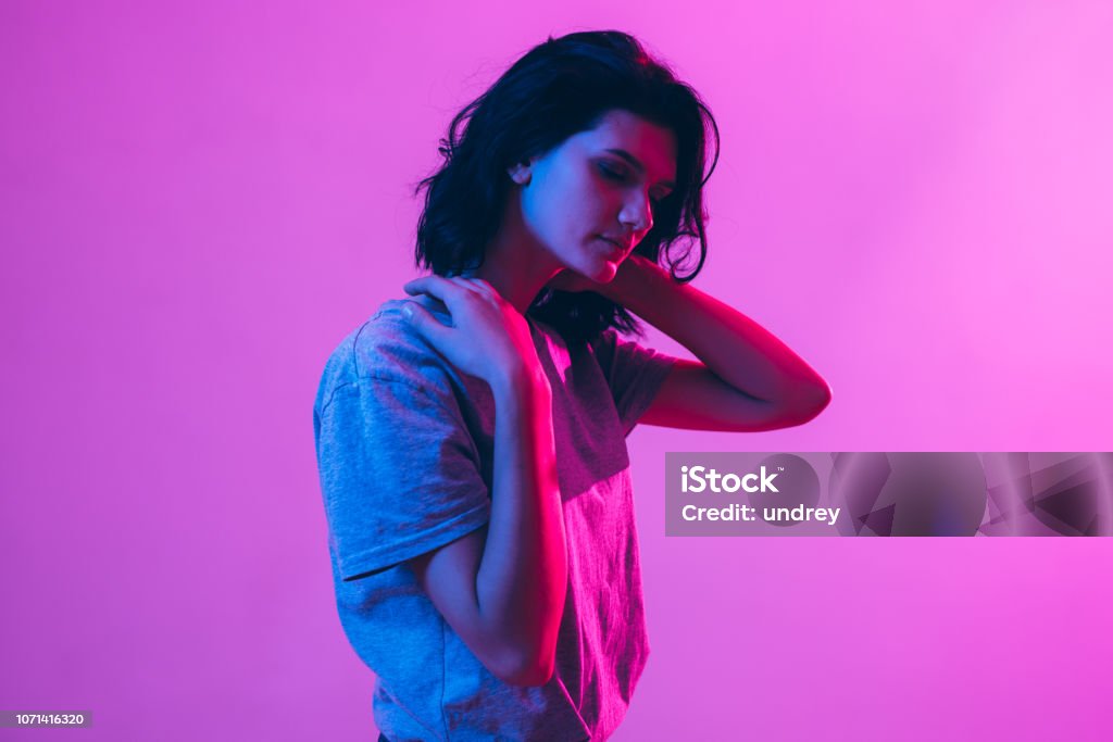 Portrait of beautiful woman. Pink, purple and blue light colors. Portrait of beautiful woman. Pink, purple and blue light colors Portrait Stock Photo