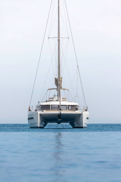 catamarano barca a vela bianca sull'oceano vicino alla spiaggia. - ketch foto e immagini stock