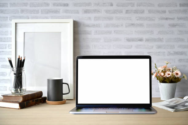 istock Creative desk workspace with blank picture frame poster, blank screen laptop for graphic display montage 1071418706