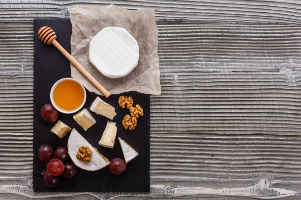 istock delicious creamy camembert cheese on a wooden rustic background 1071420436