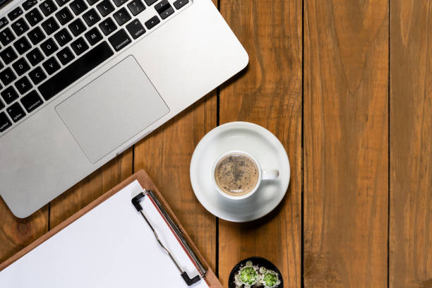 istock Wooden office table with notebook computer and a cup of coffee 1071423394