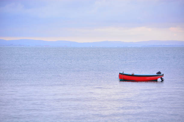 Simplicity style photograph of a fishing boat and calm seas.