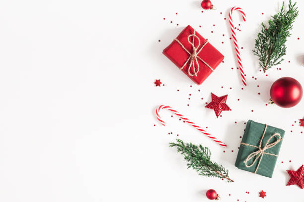 istock Christmas composition. Gifts, fir tree branches, red decorations on white background. Christmas, winter, new year concept. Flat lay, top view, copy space 1071429332