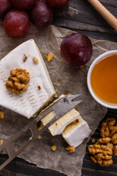 istock delicious creamy camembert cheese on a wooden rustic background 1071430462
