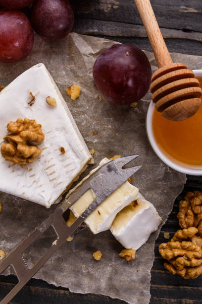 istock delicious creamy camembert cheese on a wooden rustic background 1071430504