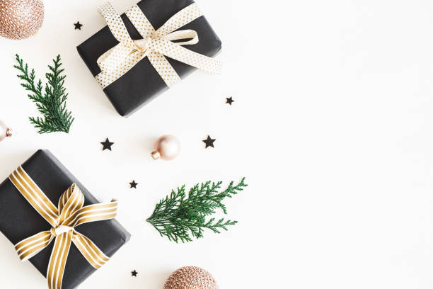istock Christmas composition. Gifts, fir tree branches, black and golden decorations on white background. Christmas, winter, new year concept. Flat lay, top view, copy space 1071430652