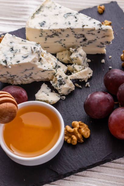 istock delicious blue cheese on wooden rustic background 1071431478
