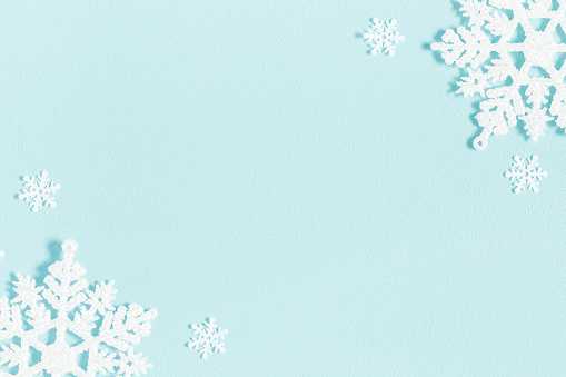 Christmas or winter composition. Pattern made of snowflakes on pastel blue background. Christmas, winter, new year concept. Flat lay, top view, copy space