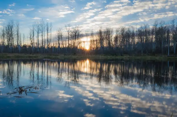 Sunset on the lake, a bright sky that is reflected in the water