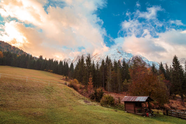 an alpine hut in the valley during a colorful sunrise