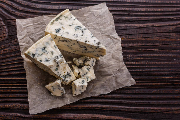 istock delicious blue cheese on wooden rustic background 1071441722