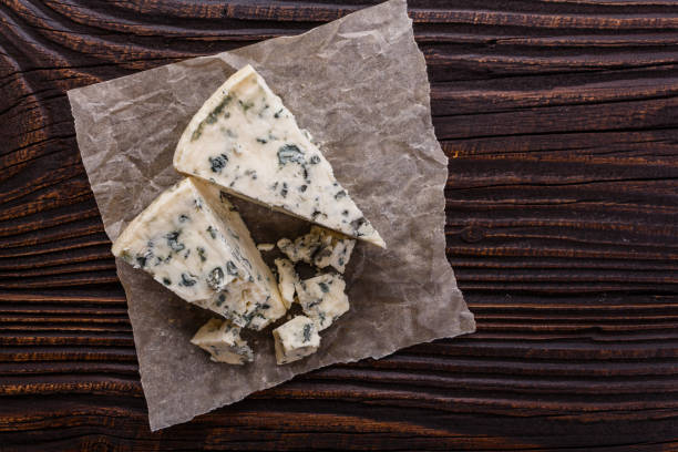 istock delicious blue cheese on wooden rustic background 1071441748