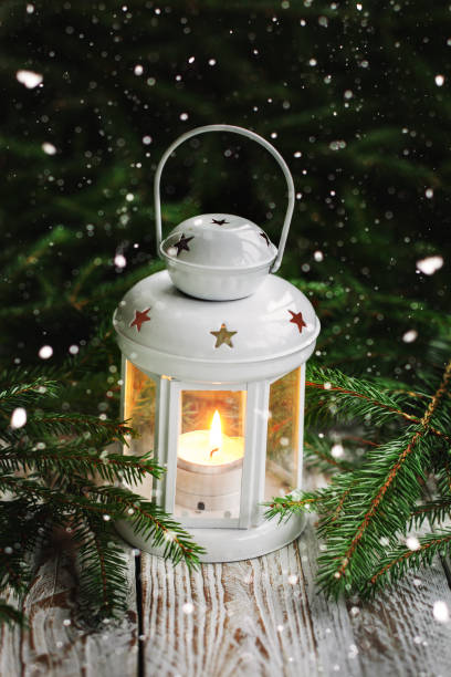 istock Christmas decoration with white candle lantern on fir tree branches background. 1071443778