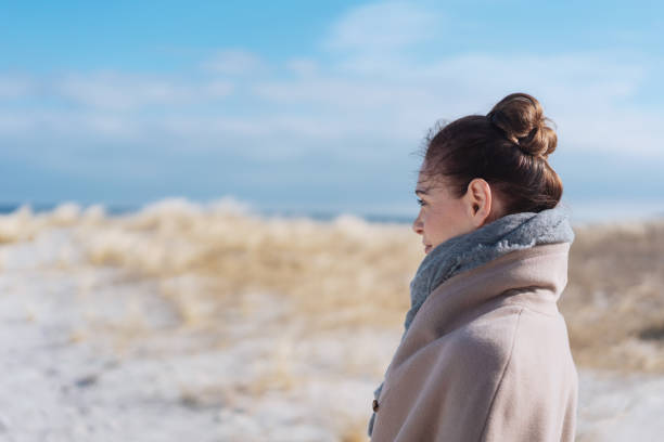 istock Attractive woman walking on a sandy beach 1071443978