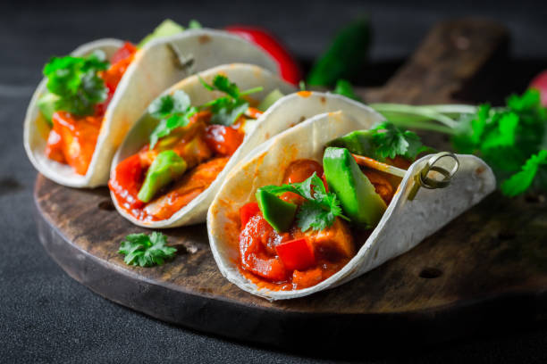 istock Closeup of tacos with avocado on concrete table 1071447258