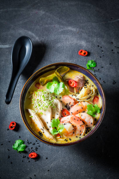 istock Malaysian Soup with chicken and shrimps on concrete table 1071448246