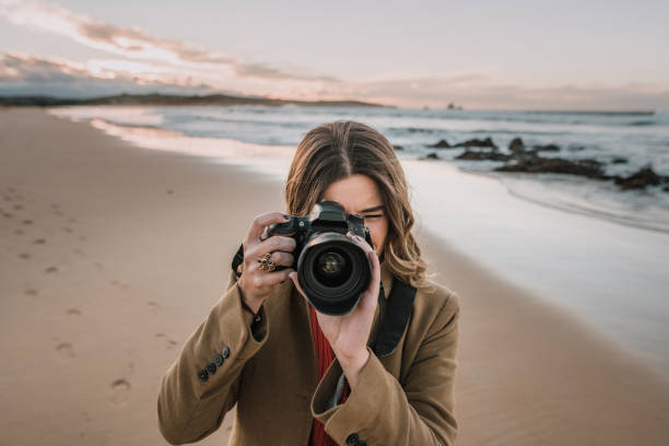 istock Young woman taking a picture with a modern DSLR camera 1071456092