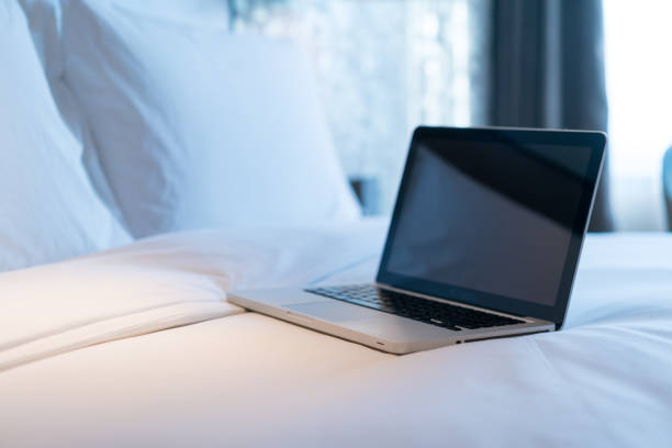 istock Working with a laptop on the bed 1071458280
