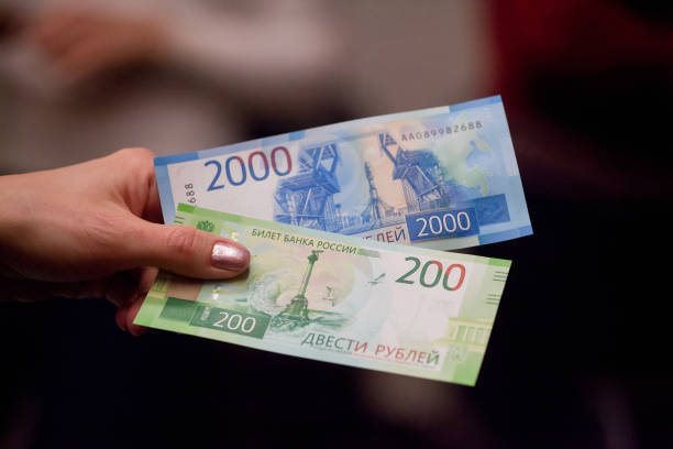 istock Russian money in the hand on a gray background. 1071460978