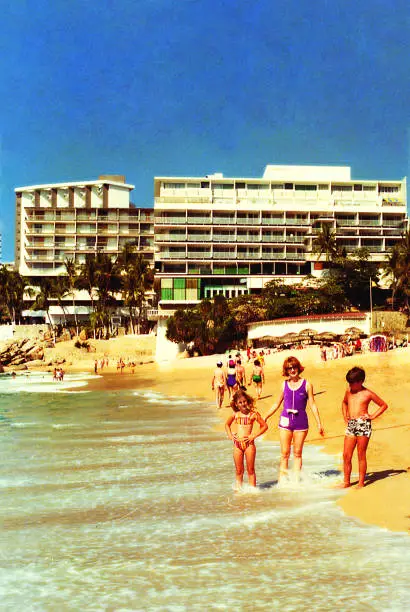 Vintage image of a mother and her children during a summer vacation in the seventies / eighties in Acapulco, Mexico.