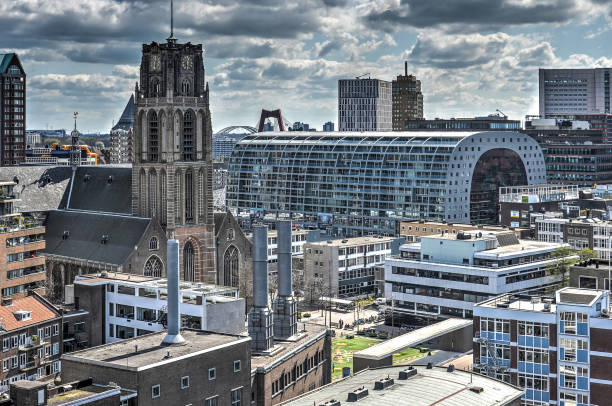 Rotterdam, the Netherlands, April 18, 2015: two prominent buildings in the city center, late-gothic Saint Lawrence church and recently completed Markthal