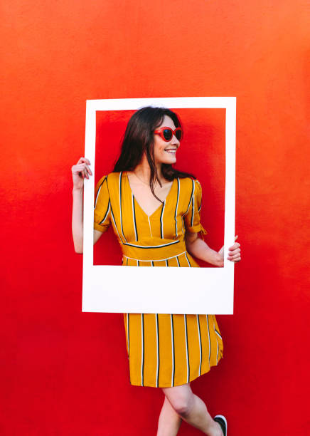 istock Beautiful woman posing with empty picture frame 1071470412