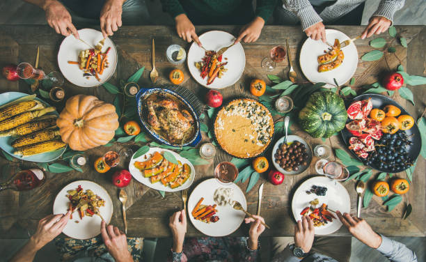 istock Friends eating at Thanksgiving Day table with turkey and snacks 1071470938