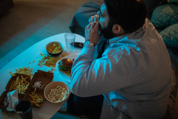 istock Man eating unhealthy dinner at home 1071471254