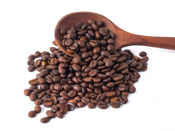 istock Roasted coffee beans on a wooden spoon on a white background 1071474474
