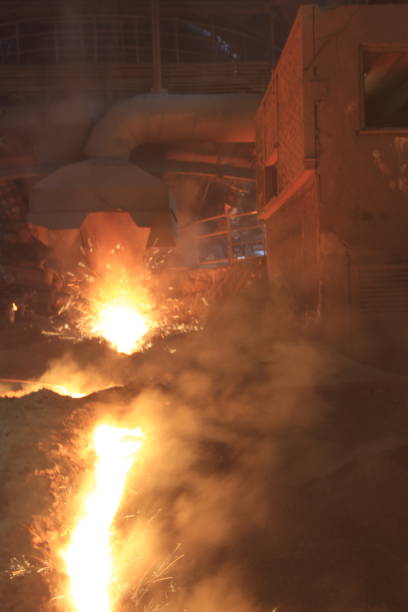 istock Iron and steel factory and working workers 1071474826