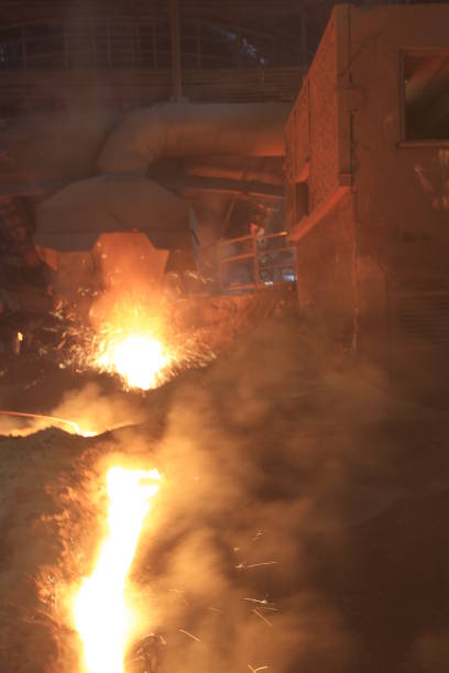 istock Iron and steel factory and working workers 1071476802