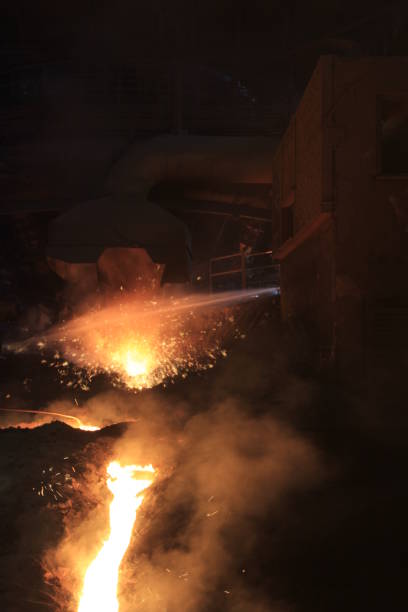 istock Iron and steel factory and working workers 1071477362