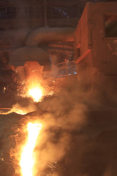 istock Iron and steel factory and working workers 1071477898
