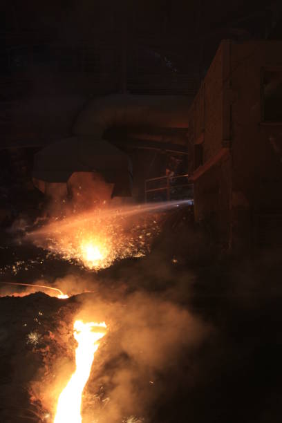 istock Iron and steel factory and working workers 1071483858