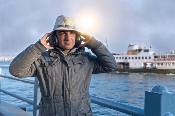 music,autumn,headphone,hat,straw hat,estuary,man,Istanbul,bridge,sea,freedom,lifestyle