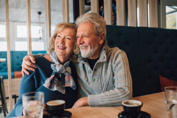 istock Mature couple hugging at coffee shop 1071500690