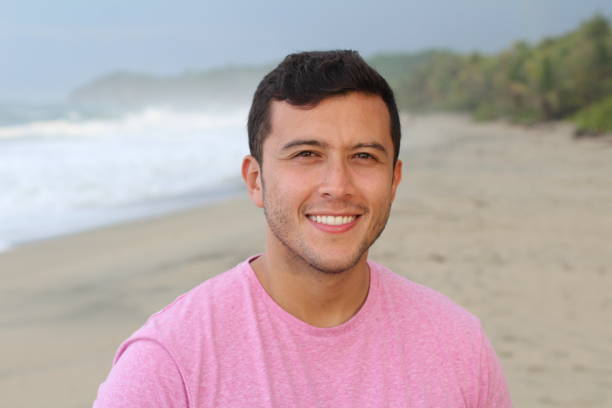 istock Man smiling at the beach with copy space 1071509272