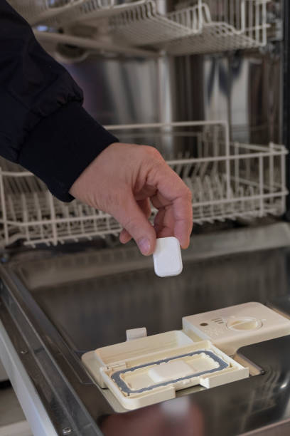 istock Tablets, detergents for the dishwasher. Man shows on pills. 1071509716