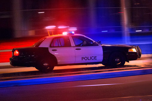 A police squad car races to the scene of an incident.