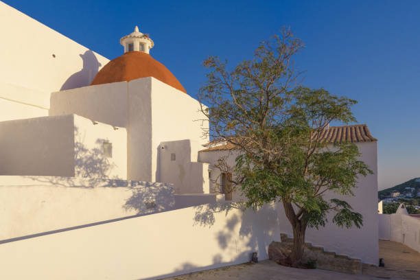 Puig de Missa, Santa Eulària des Riu, Church, Ibiza, Spain View of the old town church of Santa Eulària in the east of Ibiza, a golden sunset, clear blue sky. Developed from RAW. santa eulalia stock pictures, royalty-free photos & images