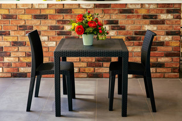 istock table and chairs against a backdrop of brick wall 1071535194