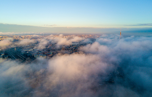 Beautiful aerial view of the clouds above the city during sunset. Beautiful aerial image.