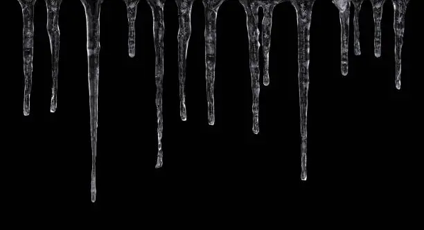 Close up of icicles isolated on black background