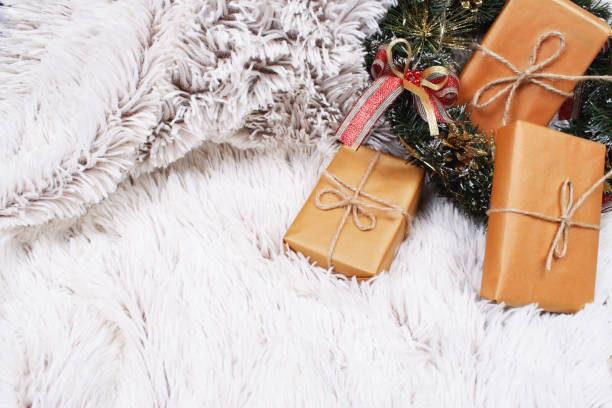 istock Christmas wreath and presents on fur. 1071540652