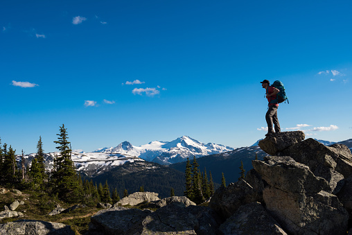 Hiker in Whistler, BC, Canada with views of alpine peaks