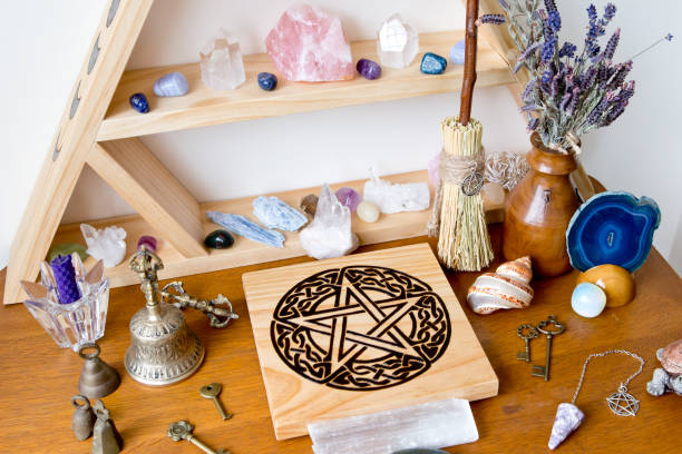 istock Pagan / Witch Altar with crystals, crystal stand, pentacle altar tile, besom, bell and herbs 1071555162